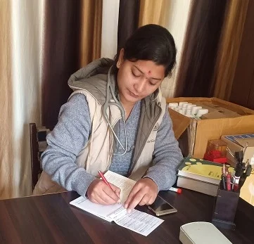 Woman writing at a desk indoors