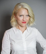 “Blonde woman in a white shirt looking at the camera”