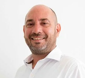 “Smiling bald man in a white shirt”