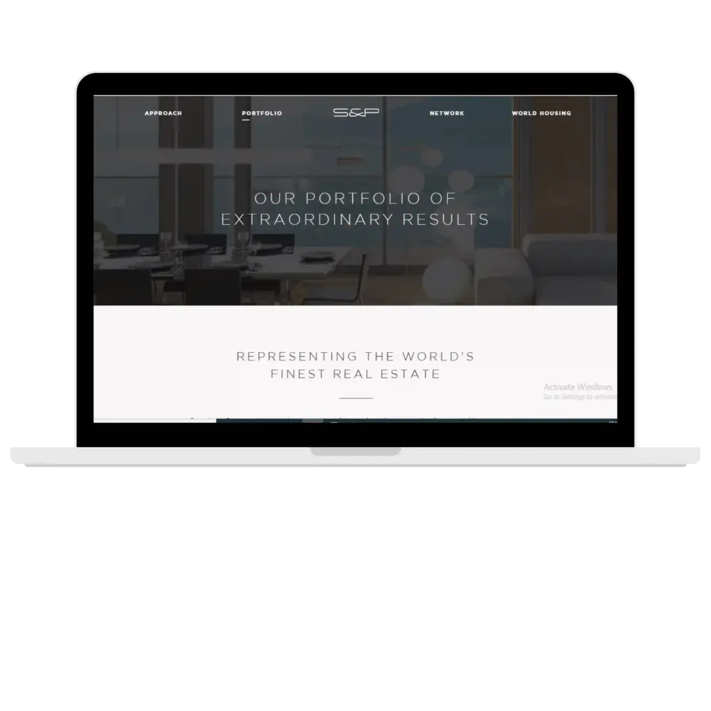 Laptop displaying a luxury real estate portfolio website