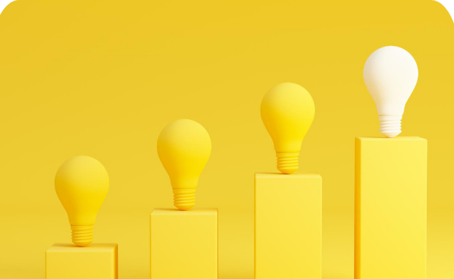 Four light bulbs on yellow blocks, showing ideas/growth from left to right.